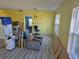 Dining room with new flooring and yellow walls, still under renovation at 21459 Olean Blvd, Port Charlotte, FL 33952