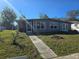 Newly renovated house exterior with gray siding and a walkway at 21459 Olean Blvd, Port Charlotte, FL 33952