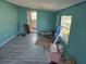 Under-construction living area with new flooring and teal walls at 21459 Olean Blvd, Port Charlotte, FL 33952