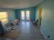 Open living area with French doors, fresh paint, and new flooring at 21459 Olean Blvd, Port Charlotte, FL 33952
