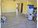 Living room with new gray vinyl plank flooring and yellow walls at 21459 Olean Blvd, Port Charlotte, FL 33952