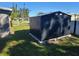 Black metal storage shed in the backyard at 21459 Olean Blvd, Port Charlotte, FL 33952