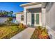 Charming home entrance with a walkway, landscaping, and a modern double-door entry at 2258 Margaret Ln, North Port, FL 34286