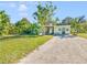 Light green house exterior with a spacious lawn at 2910 49Th St, Sarasota, FL 34234