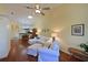 Open living room showcasing hardwood floors, a white sofa, and views into the kitchen and dining area at 2915 Oak Ln, Bradenton, FL 34209