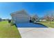 Exterior view of a single-story house with gray siding and a two-car garage at 3030 58Th E Way, Palmetto, FL 34221