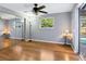 Bedroom with hardwood floors, mirrored closet, ceiling fan, and pool view at 3158 Regatta Cir, Sarasota, FL 34231