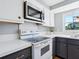 White and gray kitchen with updated stove and microwave at 3158 Regatta Cir, Sarasota, FL 34231