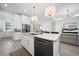 Modern kitchen with white cabinets, marble countertops, and gold accents at 319 Sherbourne St, Port Charlotte, FL 33954