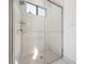 Walk-in shower with glass enclosure and modern fixtures at 319 Sherbourne St, Port Charlotte, FL 33954