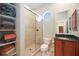 Bathroom with walk-in shower, toilet and vanity at 3706 80Th E Dr, Sarasota, FL 34243