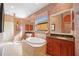 Elegant bathroom with double vanities, a soaking tub, and decorative wallpaper at 3706 80Th E Dr, Sarasota, FL 34243