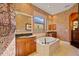 Spa-like bathroom with double vanity, soaking tub, and patterned wallpaper at 3706 80Th E Dr, Sarasota, FL 34243