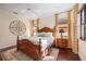 Primary bedroom with wooden bed, hardwood floors, and large windows at 3706 80Th E Dr, Sarasota, FL 34243