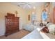 Bright bedroom with twin beds, dresser, and window seating at 3706 80Th E Dr, Sarasota, FL 34243