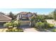 Two-story house with tile roof, landscaping, and a two-car garage at 3706 80Th E Dr, Sarasota, FL 34243
