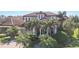 Two-story house with tile roof and palm trees at 3706 80Th E Dr, Sarasota, FL 34243