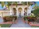 Inviting front porch with brick walkway and tropical landscaping at 3706 80Th E Dr, Sarasota, FL 34243