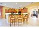 Kitchen island with seating and a view into the living area at 3706 80Th E Dr, Sarasota, FL 34243