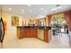 Open concept kitchen with island, stainless steel appliances and breakfast bar at 3706 80Th E Dr, Sarasota, FL 34243