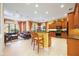 Kitchen features an island with bar stools and views into the Gathering room at 3706 80Th E Dr, Sarasota, FL 34243