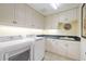 Laundry room with LG washer and dryer, cabinets and granite countertop at 3706 80Th E Dr, Sarasota, FL 34243