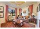Cozy living room with leather sofas, a coffee table, and large windows at 3706 80Th E Dr, Sarasota, FL 34243