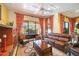 Spacious living room with leather furniture, a fireplace, and access to the pool at 3706 80Th E Dr, Sarasota, FL 34243