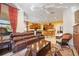 Spacious living room featuring a leather couch and access to the kitchen at 3706 80Th E Dr, Sarasota, FL 34243
