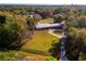 Aerial view of single-story home with large yard and circular driveway at 3825 Sarasota Golf Club Blvd, Sarasota, FL 34240