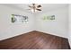 Spacious bedroom with wood-look floors and large windows at 3825 Sarasota Golf Club Blvd, Sarasota, FL 34240