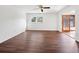 Bright bedroom with wood-look floors, ceiling fan, and access to a sunroom at 3825 Sarasota Golf Club Blvd, Sarasota, FL 34240