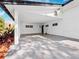 Covered carport with concrete flooring and side yard access at 3825 Sarasota Golf Club Blvd, Sarasota, FL 34240