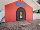Unique dog house with a bone-shaped sign and modern door at 3825 Sarasota Golf Club Blvd, Sarasota, FL 34240