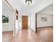 Light and airy entryway with wood door and tile flooring at 3825 Sarasota Golf Club Blvd, Sarasota, FL 34240