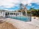 Inviting swimming pool with a safety fence in the backyard at 3825 Sarasota Golf Club Blvd, Sarasota, FL 34240