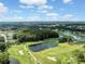 Aerial view of a serene golf course with ponds and tree-lined fairways at 3856 Trophy Blvd # 2, New Port Richey, FL 34655