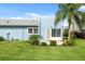 Backyard view of light blue condo with patio at 3856 Trophy Blvd # 2, New Port Richey, FL 34655
