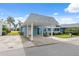 Light blue condo with carport, landscaping, and white pergola at 3856 Trophy Blvd # 2, New Port Richey, FL 34655