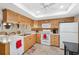 Bright kitchen with white appliances and ample wood cabinetry at 3856 Trophy Blvd # 2, New Port Richey, FL 34655