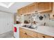 Kitchen features a double sink, light wood cabinets, and a marble countertop at 3856 Trophy Blvd # 2, New Port Richey, FL 34655