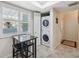 Laundry area with stackable washer and dryer, plus a small table and chairs at 3856 Trophy Blvd # 2, New Port Richey, FL 34655