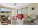Sunroom features wicker furniture, red cabinet, and access to the outdoors at 3856 Trophy Blvd # 2, New Port Richey, FL 34655
