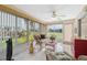 Relaxing sunroom with wicker furniture and large windows at 3856 Trophy Blvd # 2, New Port Richey, FL 34655