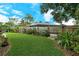 Landscaped backyard with lush lawn and mature trees at 4035 Keats Dr, Sarasota, FL 34241