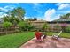 Landscaped backyard with patio, fire pit, and seating area at 4035 Keats Dr, Sarasota, FL 34241