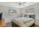 Cozy bedroom with dark-wood bed frame and ceiling fan at 4035 Keats Dr, Sarasota, FL 34241