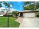 Inviting home with stone facade, landscaped lawn, and a two-car garage at 4035 Keats Dr, Sarasota, FL 34241