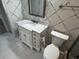 Updated bathroom with white vanity, marble countertop, and tile shower at 4119 61St Avenue W Ter # 308, Bradenton, FL 34210