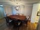 Elegant dining room with wood table, six chairs, and modern chandelier at 4119 61St Avenue W Ter # 308, Bradenton, FL 34210
